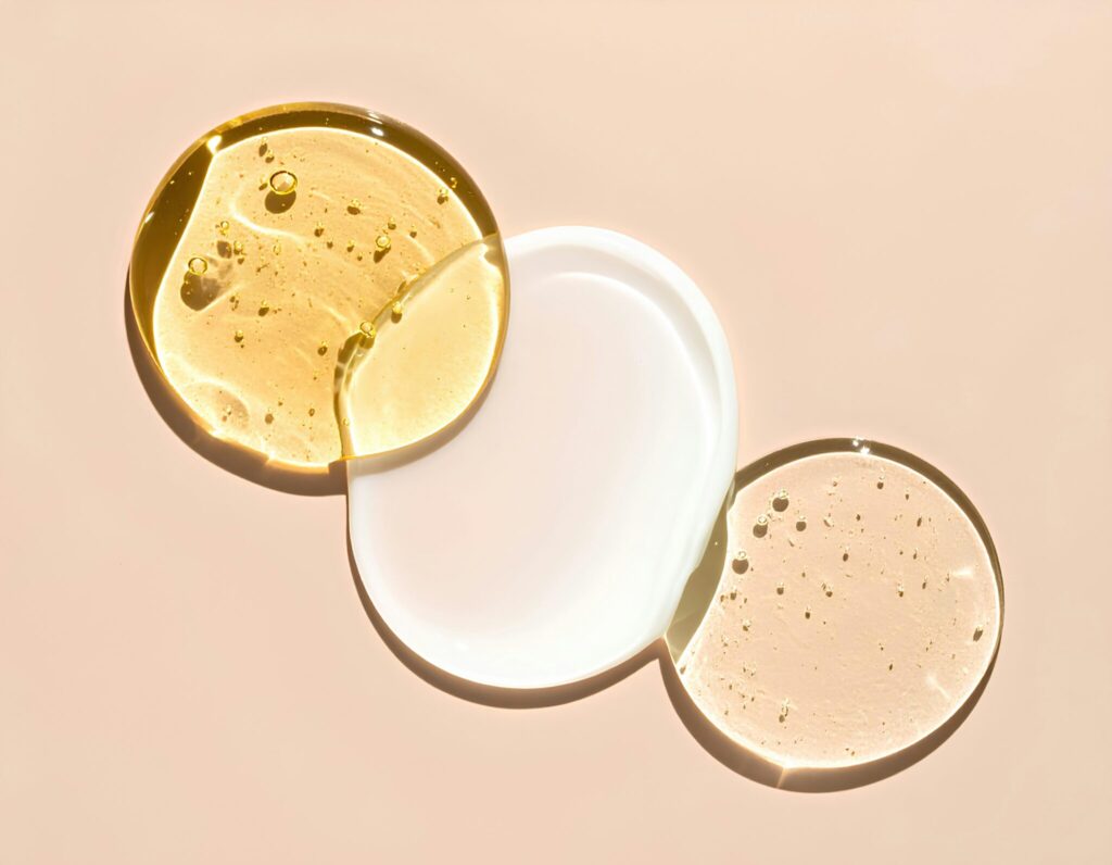 Close-up of three skincare textures showing oil, serum and cream for retinol routine